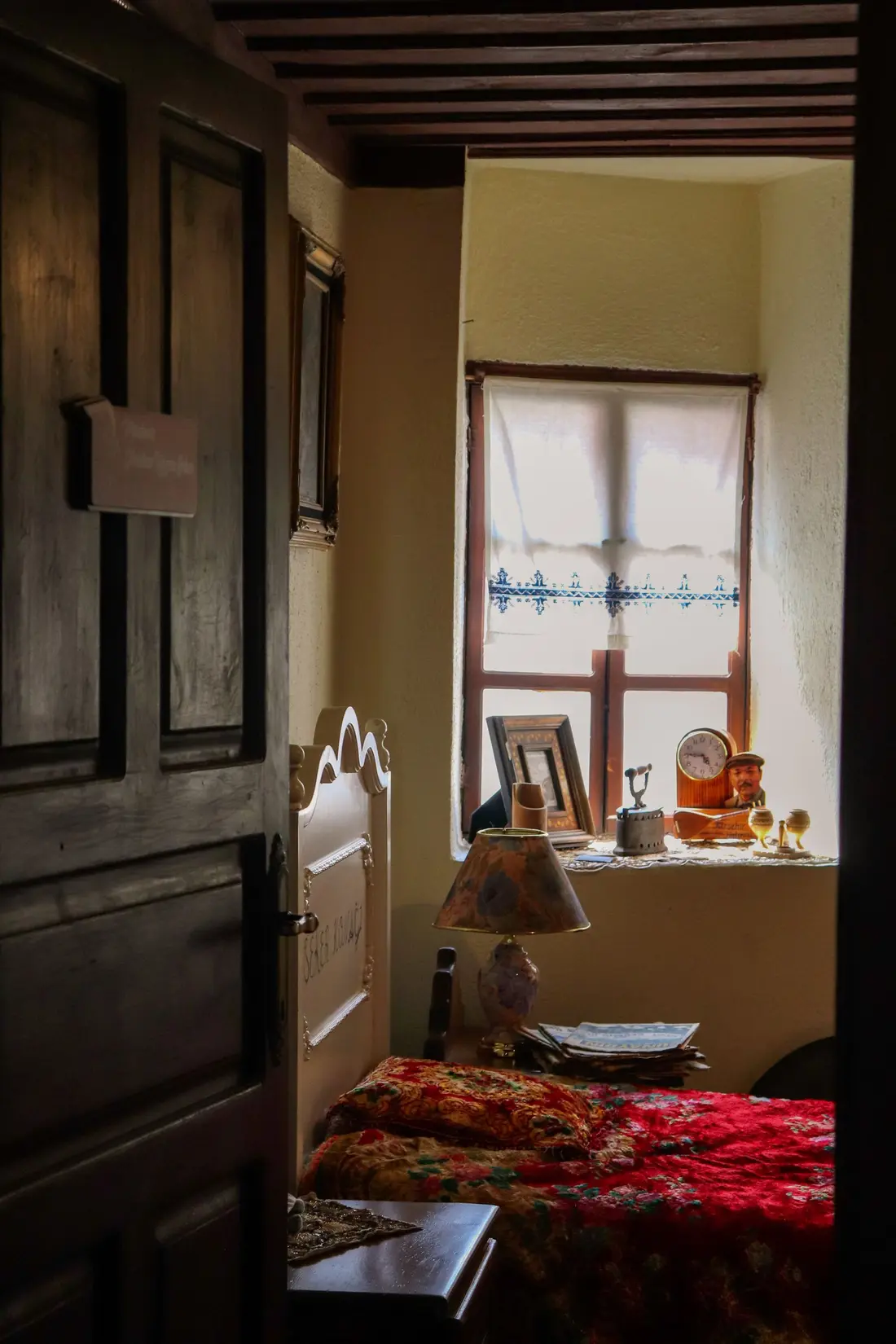 Recanto de um quarto antigo com janela e cortina de renda